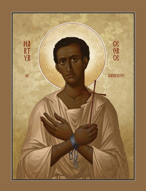 An icon of St. George holding a cross with his hands across his chest and prison cuffs on his wrists.